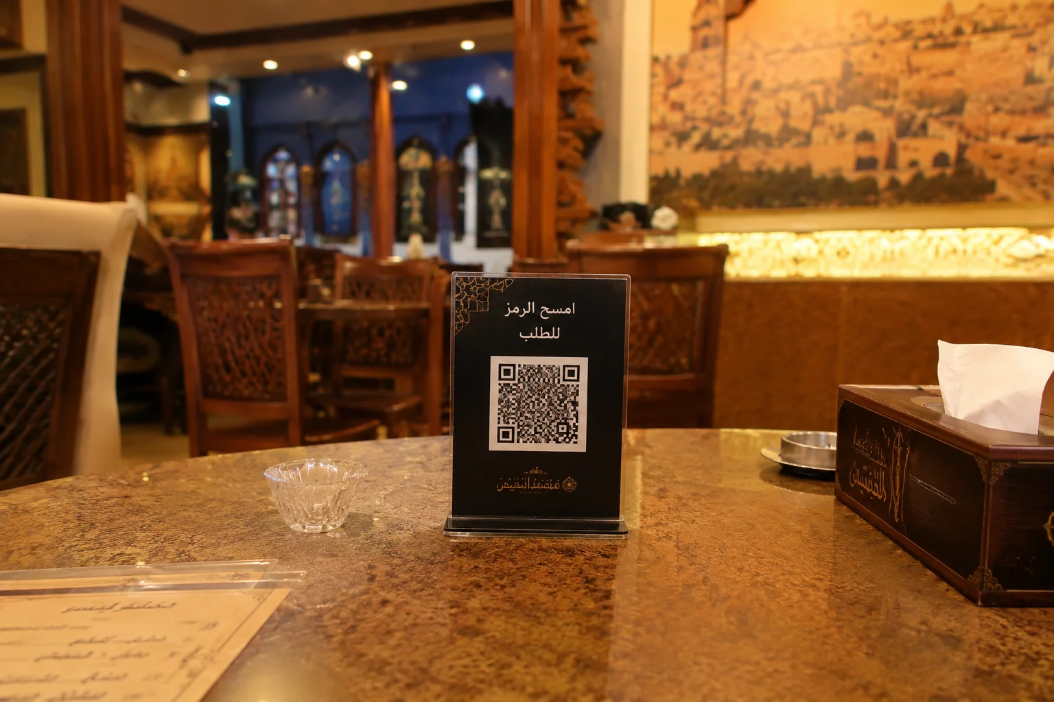 A QR code stand on a restaurant table inviting guests to scan the code to order